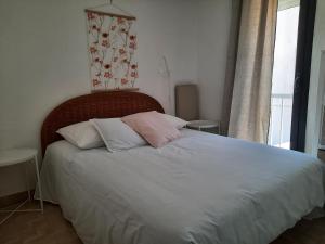 a bedroom with a large bed with two pillows at Résidence les Sables D'or in Cap d'Agde