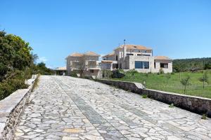 a cobble stone road in front of a house at Wild Fig Retreat Thalassa and Loft in Maryiés