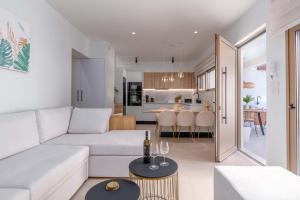 a living room with a white couch and a table at Mariann Premium Suites in Lartos +29 photos