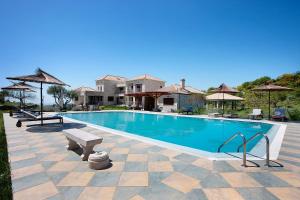 a swimming pool with a bench and a house at Wild Fig Retreat Irene in Maryiés