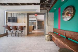 a lobby with a bar with brown chairs and a green wall at Back Bay 1BR w Gym nr Copley Sq BOS-742 in Boston