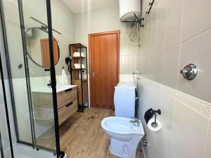a bathroom with a toilet and a sink and a shower at Mila Prestigioso Appartamento in Scalea +25 photos