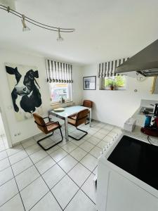 a kitchen with a table and chairs in a room at Downtown in Füssen