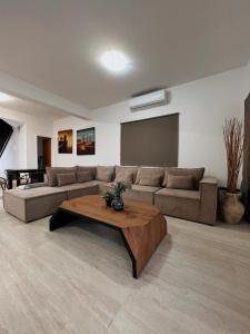 a living room with a couch and a coffee table at Oasi Rejuve Villa in Meneou