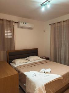 a bedroom with a bed with two towels on it at Oasi Rejuve Villa in Meneou +23 photos