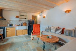 a living room with a couch and a table at Houses at Chrisopigi Sifnos in Chrisopigi
