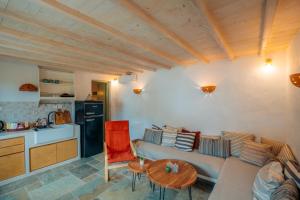 a living room with a couch and a table at Houses at Chrisopigi Sifnos in Chrisopigi
