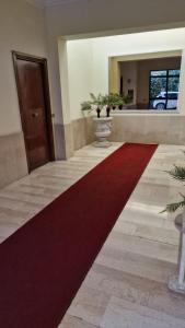 a large red carpet in a hallway with a door at Guest House Arya in Rome