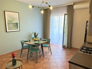 a kitchen and dining room with a table and chairs at Mila Prestigioso Appartamento in Scalea