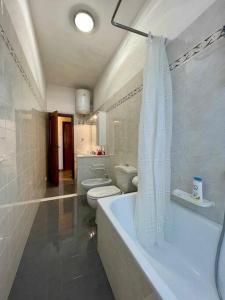 a bathroom with a tub and two toilets and a shower at Careggi Gold Colors in Florence