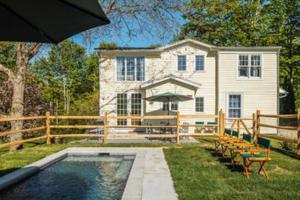 a house with a swimming pool in front of a house at Tophet Road, 3-BR with Spa Plunge Pool - PoshPadsCT in Roxbury