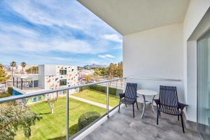 a balcony with two chairs and a table at Hotel Astoria Playa Adults Only 4* Sup in Port d'Alcudia