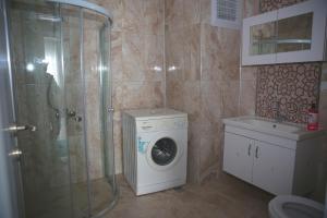 uma casa de banho com uma máquina de lavar roupa e um chuveiro em Araklı Residence em Araklı