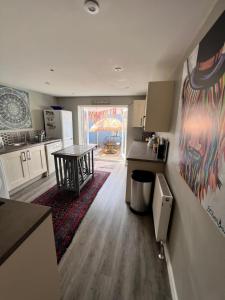 a kitchen with a table and a counter top at Time Out in Exmouth