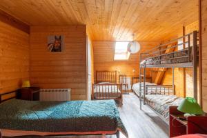 a bedroom with bunk beds in a wooden cabin at Gite Du Dombief in La Chaux-du-Dombief