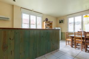 a kitchen with a green bar and a table at Gite Du Dombief in La Chaux-du-Dombief