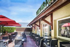 a row of tables and chairs on a patio at Logis Hotel Restaurant Bagatelle - 51530 Dizy in Épernay