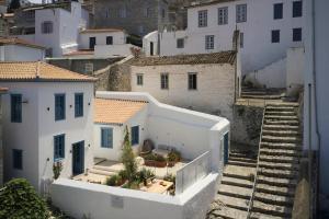 an aerial view of a city with white buildings at Orloff Legacy Suites Hydra in Hydra