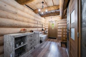 a log cabin bathroom with a fireplace and wooden walls at Chalet Durik Bystra-Jacuzzi-Sauna-Kids playground-Fire pit-Hiking in Horná Lehota