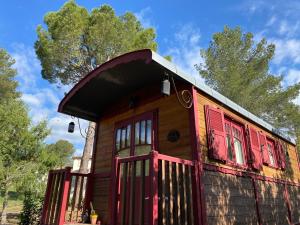 a small house with red shutters and a red door at La roulotte de La Motte in La Motte +9 photos