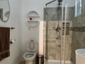 a bathroom with a toilet and a shower at condominiums in Los Angeles
