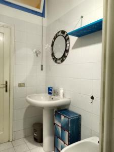 a bathroom with a sink and a mirror and a toilet at La Casina dei nipoti in Strada