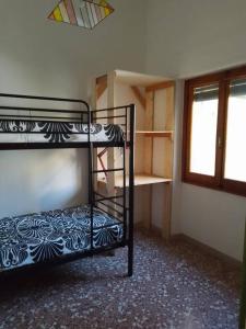 a room with two bunk beds and a window at La Casina dei nipoti in Strada
