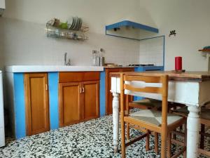 a kitchen with a sink and a wooden table at La Casina dei nipoti in Strada