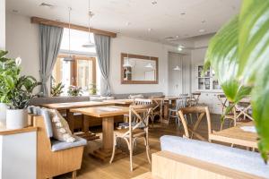 a dining room with wooden tables and chairs at W Dolinie Tylicza SPA & Wellness -gabinet masażu, saunarium-plac zabaw, rowery elektryczne, animacje dla dzieci in Krynica Zdrój