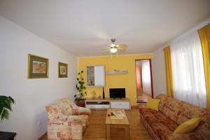 a living room with a couch and a table at Holiday apartment in village Dobrani in Rebići