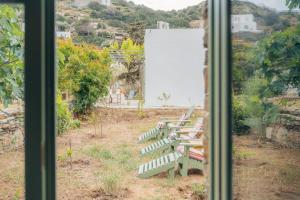 a view of a bench from a window at Houses at Chrisopigi Sifnos in Chrisopigi