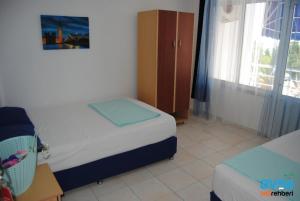 a small bedroom with two beds and a window at Studio in Avşa Adası