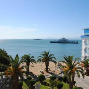 a large cruise ship in the ocean with palm trees at Studio in Avşa Adası