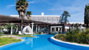 a resort with a pool and a building at Amadria Park Beach Hotel Niko in Šibenik