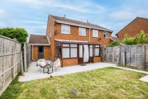 a brick house with a fence and a patio at Coventry Beautiful House, University Hospital, M6 M69, Private Parking, Sleeps 6, by EMPOWER HOMES in Coventry