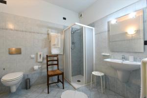 a bathroom with a shower and a toilet and a sink at Hotel Ristorante Borgovecchio in Montegrosso dʼAsti