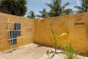 a house with a wall with two windows at Elements Beach & Nature Resort in Kalpitiya