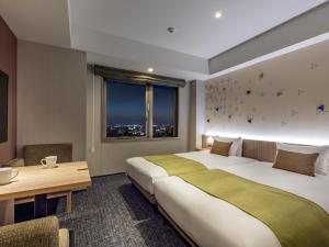 Letto o letti in una camera di Tokyu Stay Kanazawa