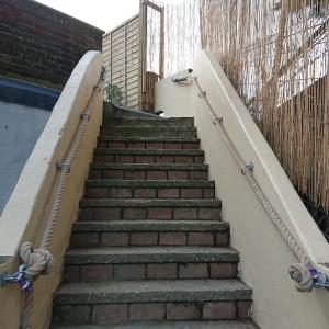 a set of stairs leading up to a building at Stylish 2 bed flat at Camber Sands in Camber