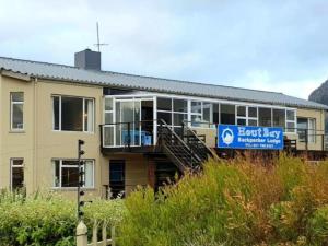 a building with a sign on the side of it at Dune Lodge in Hout Bay