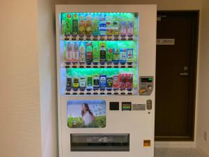 a vending machine with a display of drinks at 若 京都河原町ホテル Waka Kyoto Kawaramachi Hotel in Kyoto