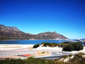 a view of a beach with mountains in the background at Dune Lodge in Hout Bay