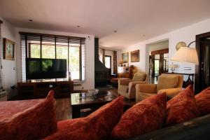 a living room with a couch and a television at TESS Villa Los Monteros in Alhaurín de la Torre