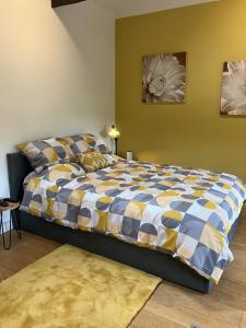 a bedroom with a bed with a blue and yellow comforter at The parlour in Bodmin