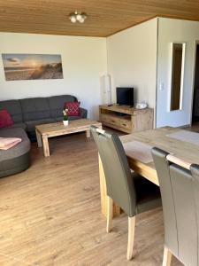 a living room with a table and a couch at Altefähr in Altefähr