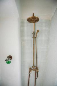a shower in a bathroom with a light on the wall at Riurau de Maria in Parcent +12 photos