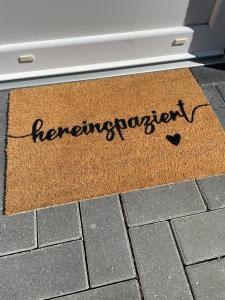 a welcome mat in front of a door with the word unemployment at Altefähr in Altefähr