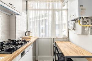 a kitchen with a stove and a window at Modern Stylish Cozy Flat in the Heart of Kadikoy in Istanbul