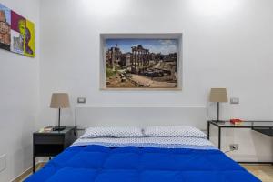 a bedroom with a blue bed and two lamps at Stradivari Suite Roma in Rome