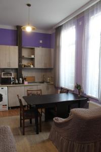 a kitchen with a table and some chairs in a room at Sweet home in Tbilisi City